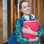 woman-standing-in-hallway-while-holding-book-1462630 Woman Standing in Hallway While Holding Book